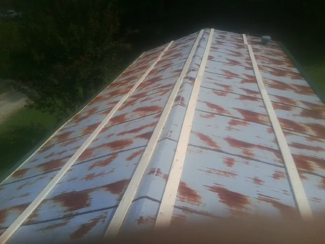 Rusted metal roof panels with new wood purlins before replacement — Storm Damage Roof Repair in Hartwell by Roofing Brothers