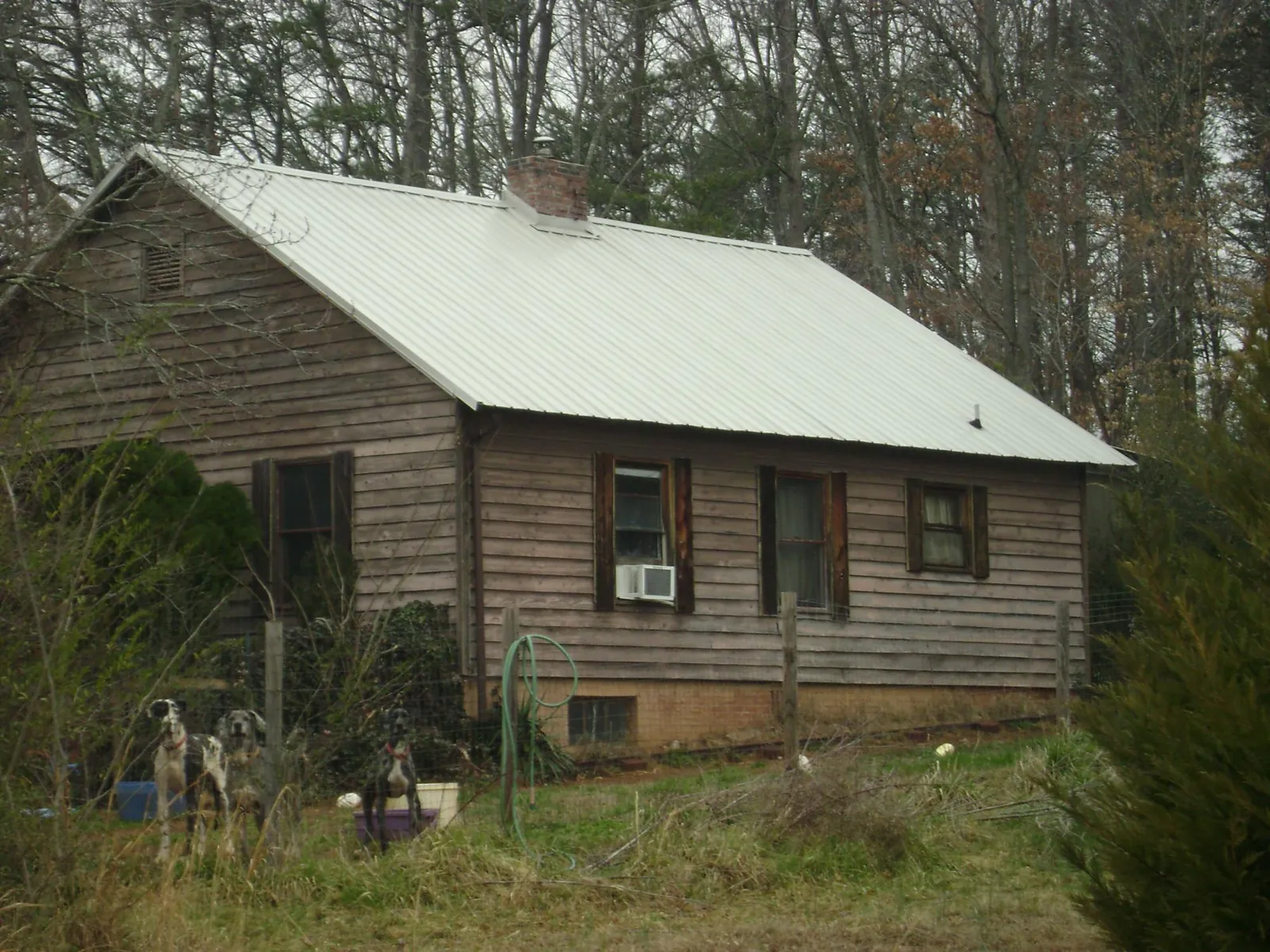White metal roof on an old wood sided farmhouse, from a Metal Roof Installation job in Hartwell